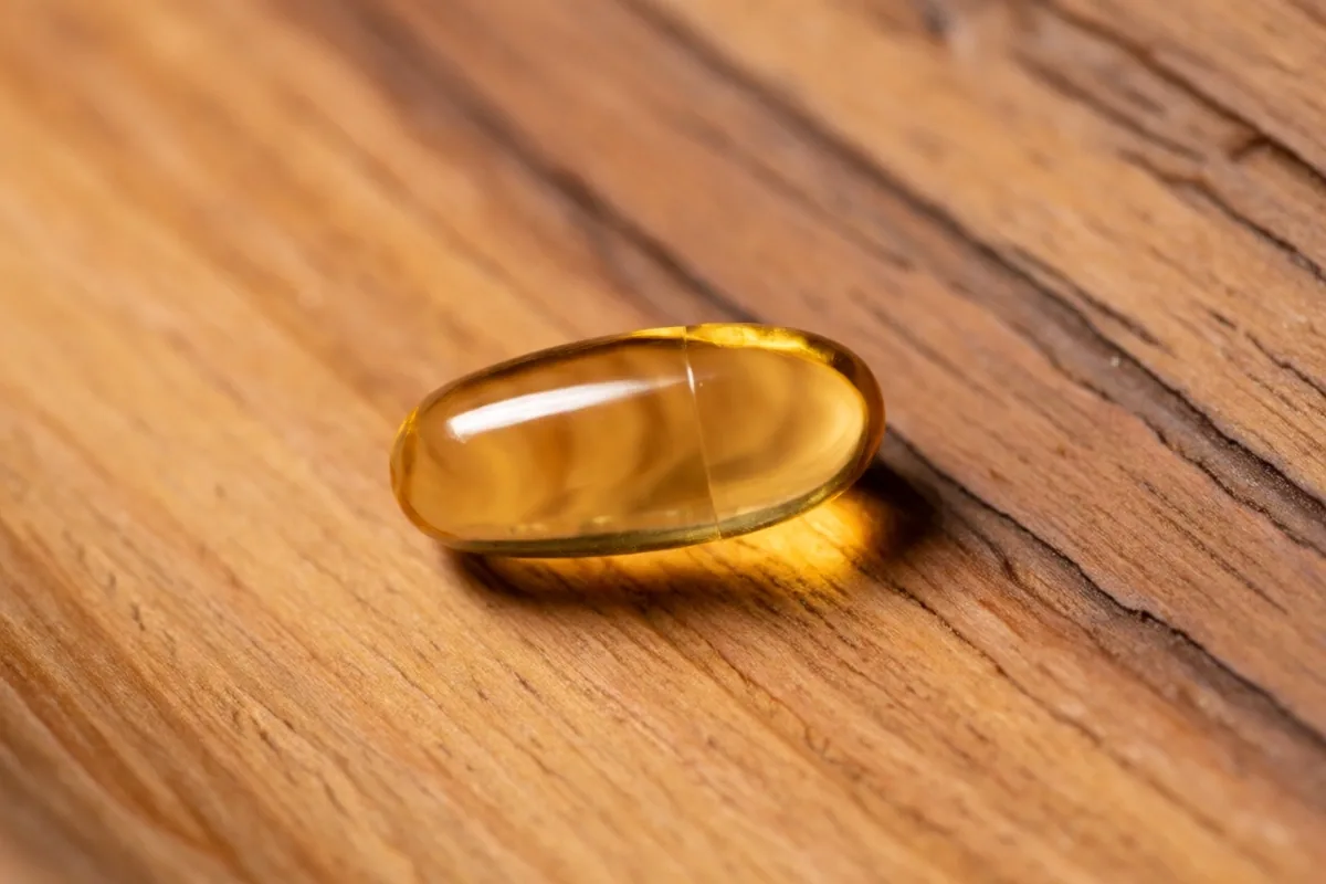 Vitamin D3 softgel capsule in warm sunlight